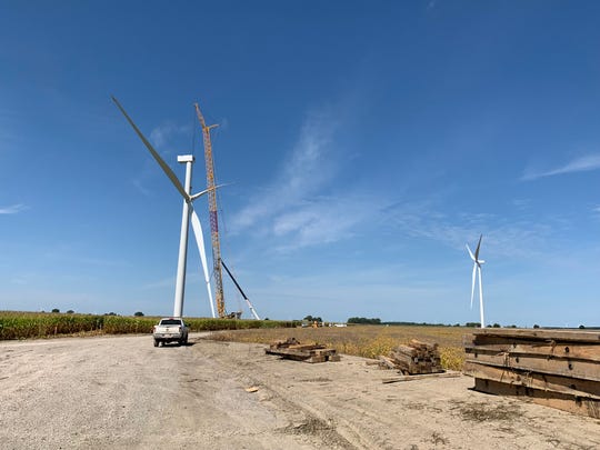 A crane hoists the blades of a new wind turbine to the top of a tower at DTE Energy's Polaris Wind Farm in mid-Michigan, recently activated according to a company announcement on April 23, 2020.
