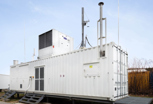 Hydrogen researchers at Graz University of Technology (Austria), together with the Graz-based start-up Rouge H2 Engineering, have developed a cost-effective process for the decentralized production of high-purity hydrogen using chemical looping. Currently, hydrogen is mainly produced centrally from fossil resources and compressed or liquefied in an expensive and energy-intensive process in order to be able to supply it to filling stations. Additionally, expensive infrastructure with high investment costs is needed there to store large quantities of hydrogen. The Fuel Cells and Hydrogen Systems Working Group at TU Graz’s Institute of Chemical Engineering and Environmental Technology has been looking for ways to make hydrogen production more attractive. As part of the HyStORM (Hydrogen Storage via Oxidation and Reduction of Metals) research project, the team led by working group head Viktor Hacker developed a chemical-looping hydrogen method for decentralized and climate-neutral hydrogen production. The research resulted in a compact and space-saving on-site, on-demand (OSOD) system for filling stations and energy plants and is being developed and distributed by the Graz-based start-up Rouge H2 Engineering. The OSOD system is a hydrogen generator with integrated storage device in one system. Hydrogen is produced by converting biogas, biomass or natural gas into a syngas. The provided energy is then stored by means of a redox process (reduction-oxidation process) in a metal oxide, which can be stored and transported without any losses or safety risks. OSOD H2 generator. The blue cuboid is the core development: a gas furnace with four tubular reactors in which the chemical looping process for hydrogen production takes place. ? RGH2 The subsequent demand-oriented production of hydrogen is achieved by feeding water into the system. The iron-based material is charged with steam and high-purity hydrogen is released. This process also makes the system interesting for smaller applications. For this reason, the OSOD system is freely scalable and is particularly suitable for decentralized applications with low feed-in rates in laboratories and smaller industrial systems as well as larger decentralized units such as hydrogen filling stations or hydrogen production from biogas. In addition to the provision of high purity hydrogen, Gernot Voitic, lead project manager of R&D at Rouge H2 Engineering, points out that the OSOD system can switch to standby mode in the case of low demand and resume hydrogen production at any time if required. Rouge H2 Engineering and TU Graz researchers are already focusing on the next step. At present, the system is still operated on an industrial scale with natural gas. The working group now wants to make it usable for biogas, biomass and other regionally available raw materials. Biogas plants, for example, could thus become even more competitive in the future and, instead of electricity, also produce green hydrogen, which could be used for sustainable mobility concepts. The HyStORM research project is anchored in the Field of Expertise “Mobility & Production” at TU Graz, one of the five strategic research foci of the university. Resources Bock, S., Zacharias, R., Schauperl, R., Voitic, G., & Hacker, V. (2020). “Decentralized hydrogen generation and energy storage from biomass and biogas with Fixed-Bed Chemical Looping.” In 6th Central European Biomass Conference CEBC 2020, Proceedings (pp. 59). Graz. Robert Zacharias, Simone Visentin, Sebastian Bock, Viktor Hacker (2019) “High-pressure hydrogen production with inherent sequestration of a pure carbon dioxide stream via fixed bed chemical looping,” International Journal of Hydrogen Energy, Volume 44, Issue 16, pages 7943-7957 doi: 10.1016/j.ijhydene.2019.01.257 (open access)