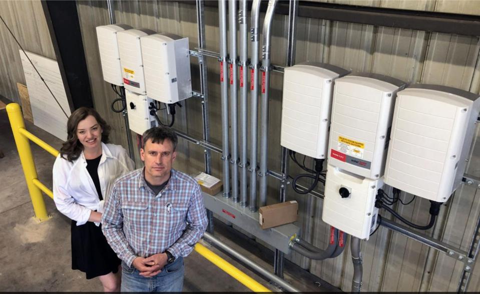 Keena Mullins and Zach Drennen, co-founders of Revolt Energy that is now part of Nitro Construction Services pose at solar site in West Virginia.  BOB SAUNDERS, OF THE DAILY MAIL WV