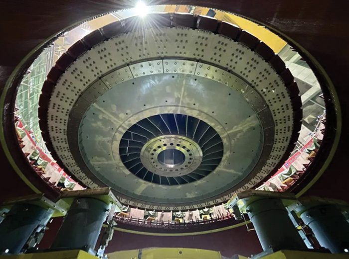  The 16-GW Baihetan hydropower plant features 1-GW hydropower turbines. This image shows crews hoisting the rotor for its right bank No. 13 power unit in April 2021. Courtesy: China Three Gorges Corp. 